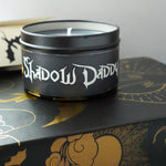 shadow daddy candle on top of a book